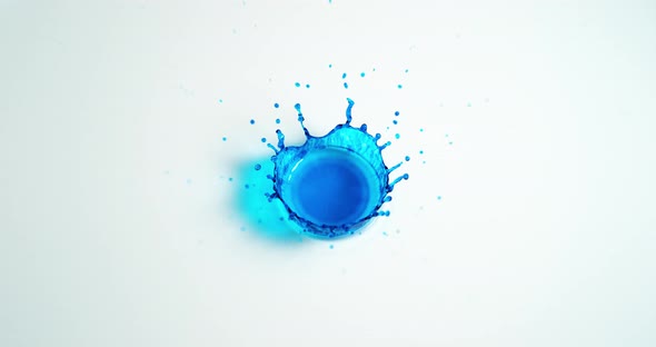 Blue Liquid falling into Water against White Background, Slow motion 4K