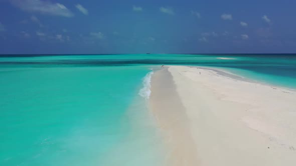 Aerial drone shot seascape of perfect coastline beach break by blue ocean and white sandy background