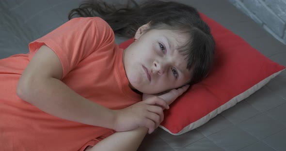 Unhappy Little Girl on Sofa