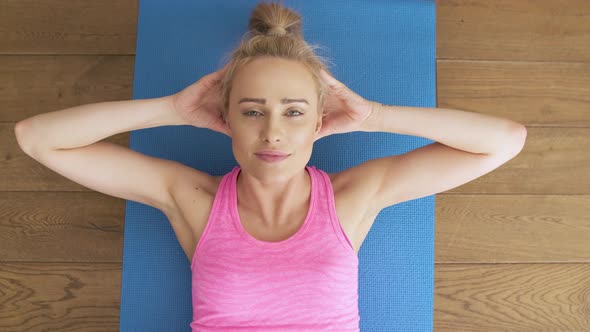 Fitness Determined Middle Aged Woman Lying Doing Crunches at Home on Gym Mat