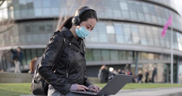 Chinese woman in London working at park and wearing face mask to protect from