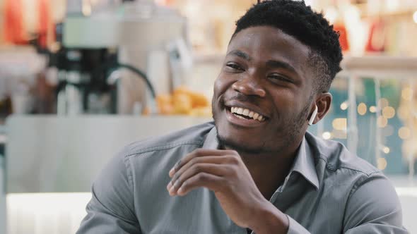 Closeup Young Happy African American Man Talking Through Wireless Headphones Smiling Answering