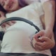 Happy Asian husband and pregnant wife spend time together turning on music for an unborn baby. - VideoHive Item for Sale