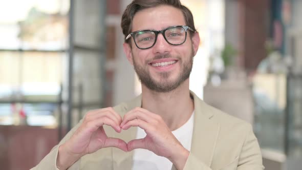 Young Man Showing Heart Sign By Hand