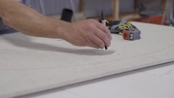 Worker preps board for radial cut