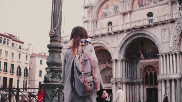 Camera Follows Fashionable Female Freelance Worker Taking Photos of Old St Mark Cathedral Building