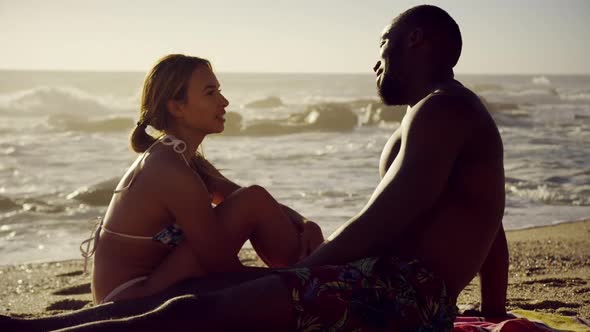 Couple interacting with each other on the beach 