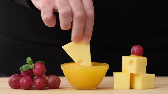Man tasting cheese with honey and grapes. Cheese Honey and Grapes