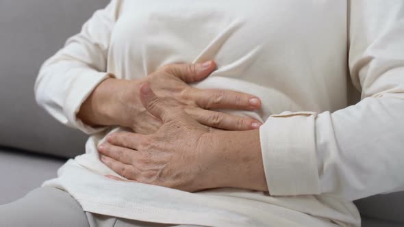 Mature Female Holding Hands on Tummy, Abdominal Pain, Gastritis Health Problem