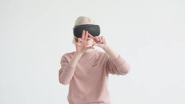 Virtual Reality Game. Young Albino Teenager with Pleasure Uses Head-mounted Display