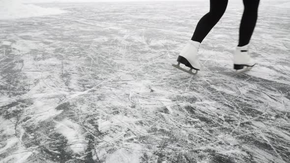 Legs ice skating on frozen rink