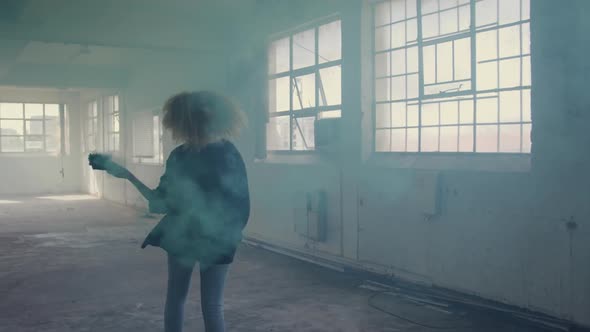 Fashionable young woman in an abandoned warehouse