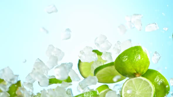 Super Slow Motion Shot of Flying Fresh Lime Slices and Crushed Ice on Background at 1000 Fps