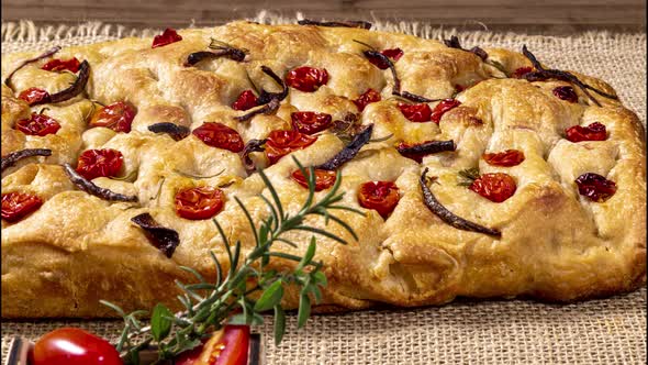 Traditional Italian Focaccia with pepperoni, cherry tomatoes, black olives, rosemary ando onion - ho