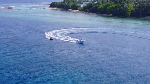 Wide angle scenery of sea view beach journey by blue water and sand background near sandbank