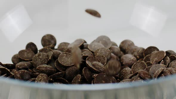 Preparing Handmade Chocolate, Chips Couverture Callets Fall in Bowl Slow Mo