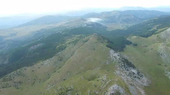 Aerial view of smoke rising above Dinara mountain tops