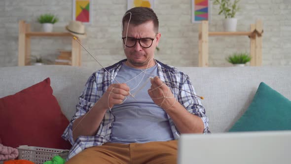 Portrait Young Man Clumsily Knitting