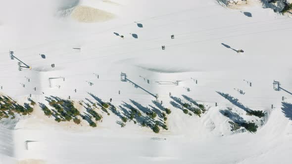 Aerial Snowfall Over Skiers and Snowboarders on Mammoth Lake Ski Mountain