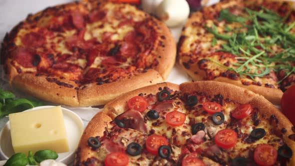 Three American Style Pizzas Served on a Table