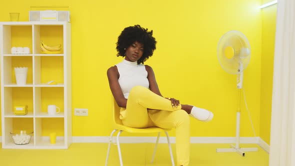 Portrait of African Woman Sitting In Yellow Office