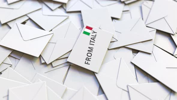 Envelope with From Italy Text on Pile of Other Envelopes alt