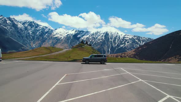 Aerial View of Parking Lot Near Gergeti Trinity Church in the Kazbegi Mountains Georgia