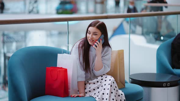 Woman Talking on Phone After Shopping
