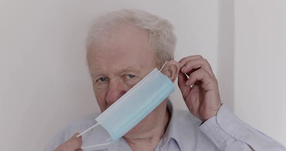 Portrait of Confident Elderly Man Wears Medical Mask for Safety During Pandemic