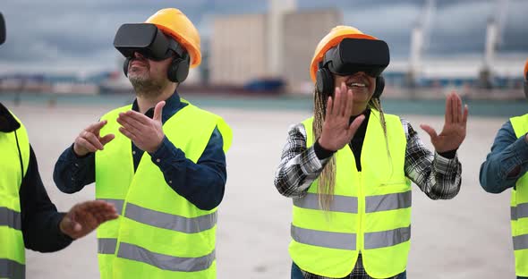 Multiracial workers using virtual reality headsets at industrial terminal Port