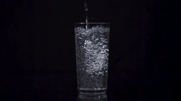 Filling Glass with Fresh Mineral Water