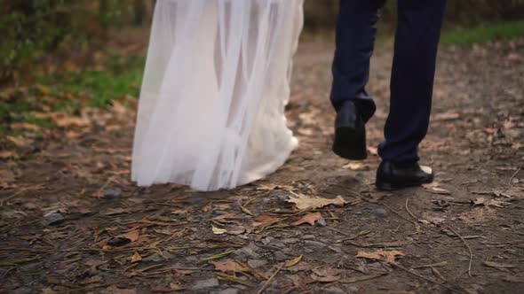 Bride and Groom Walking in the Park