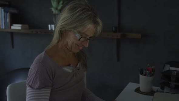 Woman using computer at home at night