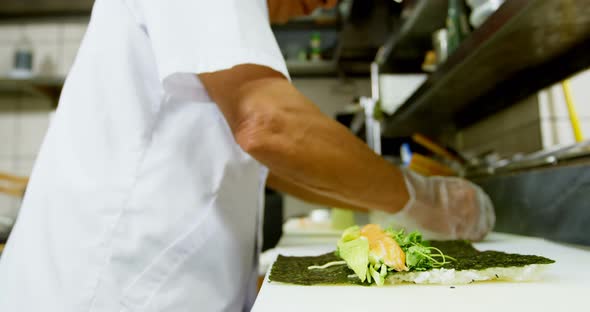 Male chef preparing sushi in kitchen 4k