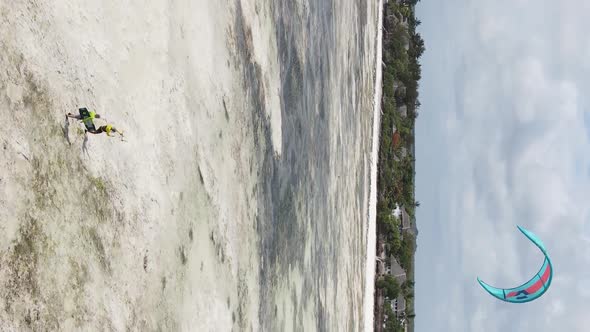 Vertical Video Kitesurfing Near the Shore of Zanzibar Tanzania Aerial View