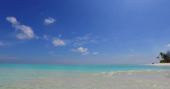 Daytime fly over tourism shot of a paradise sunny white sand beach and aqua turquoise water backgrou