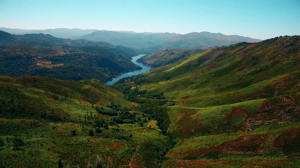 High Overview of Stunning Lake Surrounded by Mountains and Forest