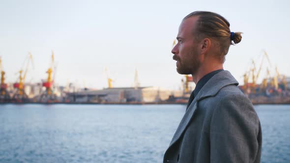 Young Stylish Redhead Handsome Hipster Man on Sea Port Background During Sunset