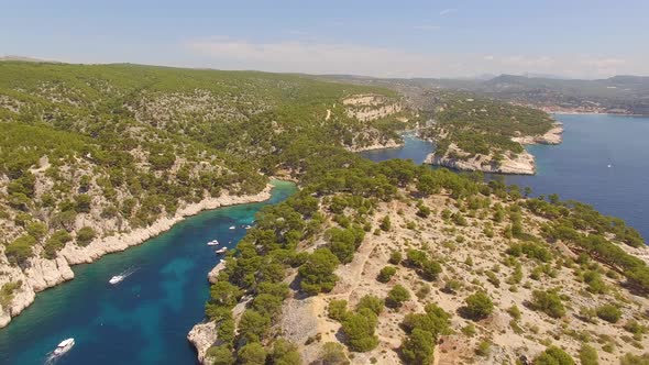 Aerial travel drone view of clear green water, cliffs of Cassis, Mediterranean Sea, Southern France.