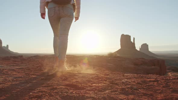 Woman Climbs Up Mountain in Hiking or Mountain Boots on Sunny Sunrise or Sunset