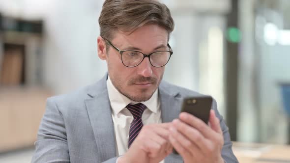 Portrait of Businessman Using Smartphone