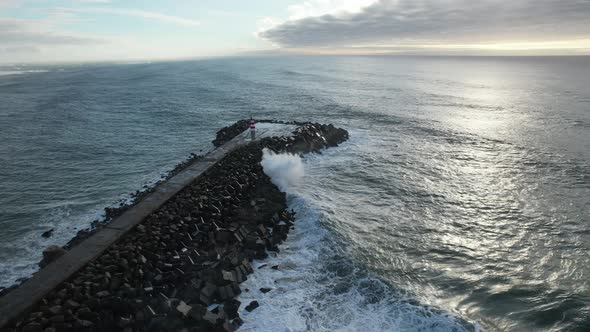 Aerial top view of sea waves hitting rocks on the beach