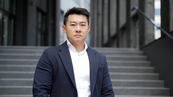 portrait of a young confident successful asian businessman looking at camera.