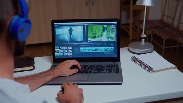 Videographer Working with Video Footage on Laptop