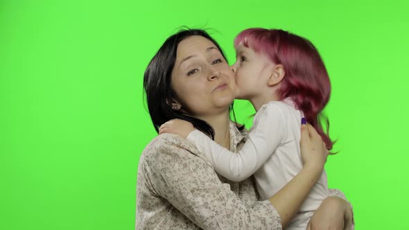 Mother and Daughter Enjoying Playing, Hug, Embrace, Kiss. Mothers Day. Family