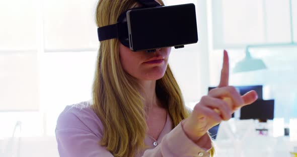 Female executive using virtual reality headset