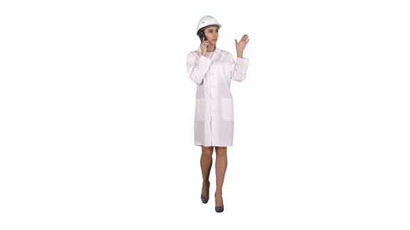 Woman engineer talking on the phone while walking on white