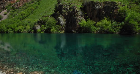 Small Mountain Lake of  blue color Urungach. Located in Uzbekistan, Central Asia. 5 out of 10