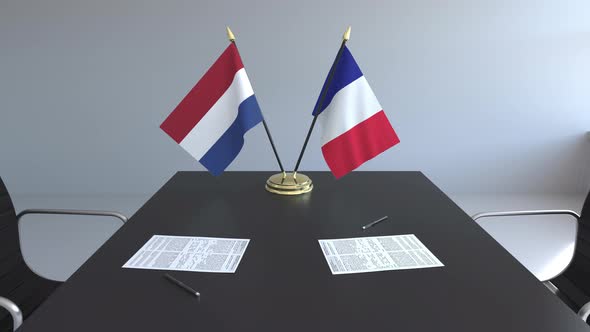 Flags of the Netherlands and France on the Table