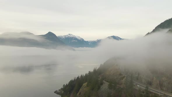 Aerial panoramic view of Sea to Sky Highway near Horseshoe Bay during a sunny winter evening before